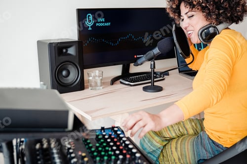 Preview: Happy Afro woman recording podcast radio show while broadcasting inside production studio