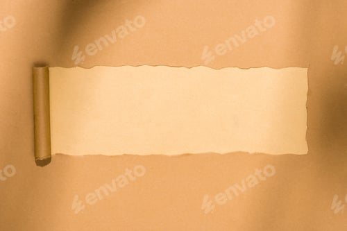 Preview: top view of empty ripped cardboard paper on beige