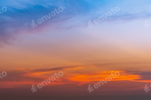 Preview: Dramatic blue and orange sky and clouds abstract background. Red-orange clouds on sunset sky. Warm