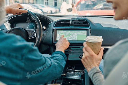 Preview: Close up rear view of active senior couple using global positioning system
