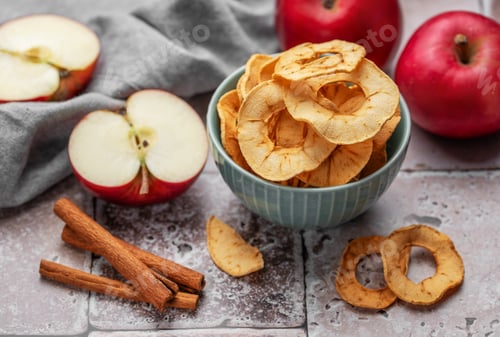 Red Apples and Cinnamon Sticks on Counter