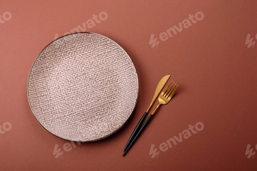 Preview: Empty ceramic plate on a monochrome brown background