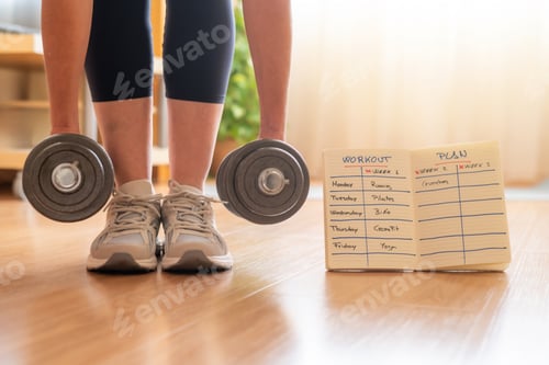 Preview: Woman exercising with dumbbells implementing a home workout plan