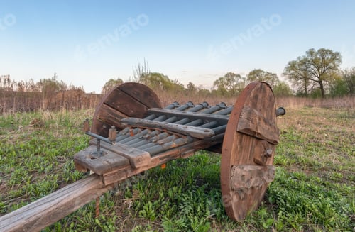 Preview: An old cannon with several gun barrels with a wooden carriage, a side view