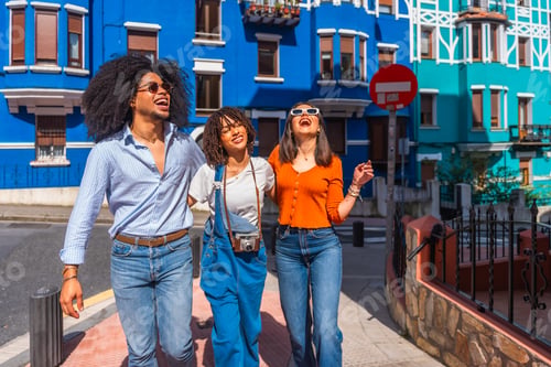 Preview: Happy tourists walking and having fun in colorful city street