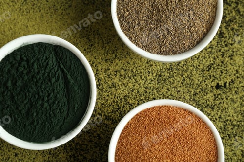 Preview: Different superfood powders in bowls on table, flat lay