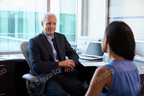 Preview: Doctor In Consultation With Female Patient In Office