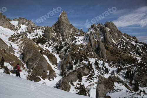 Preview: Hikers gazing at a majestic, snow-covered mountain peak