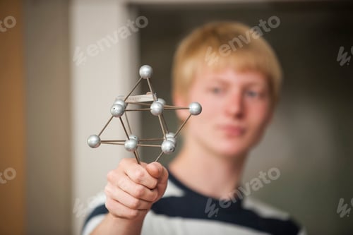 Preview: Vocational school student holding atomic model
