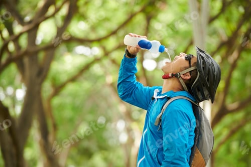 Preview: Thirsty Cyclist Drinking Fresh Water