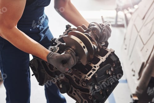 Preview: Professional repairman works with broken automobile engine