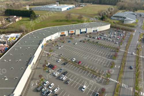 Preview: Aerial view of many colorful cars parked on parking lot with lines and markings