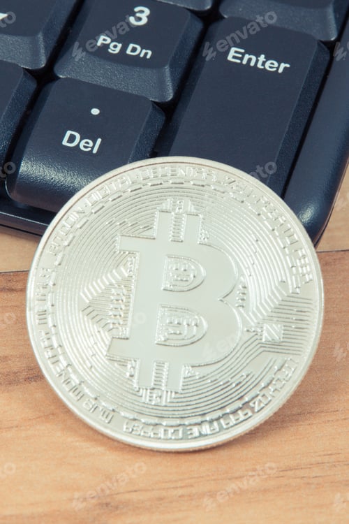 Preview: Silver Bitcoin and computer keyboard, symbol of virtual money and mining cryptocurrency concept