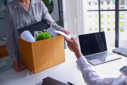 Preview: Female employee deliver a resignation letter in a white envelop to her manager