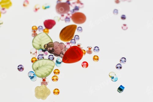 Preview: Colorful crafting beads on a white background