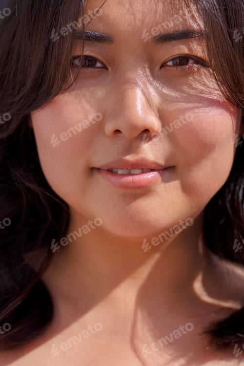 Preview: Asian woman with long dark hair, smiling softly in natural light
