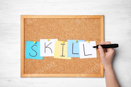 Preview: Woman writing word SKILL on sticky notes pinned to cork board. Business trainer concept