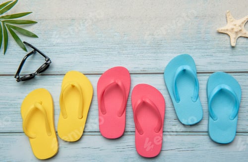 Preview: Colorful flip flops and sunglasses resting on beach boardwalk, embracing summer vibes