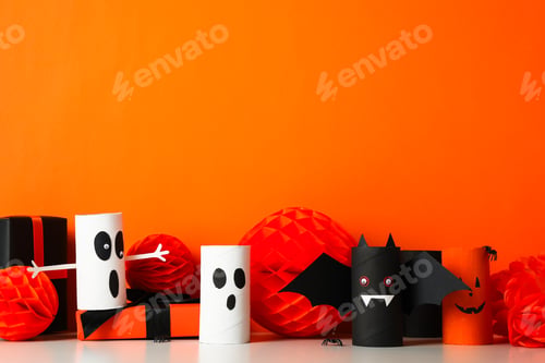 Preview: Gift boxes and paper Halloween mockups on orange background, space for text