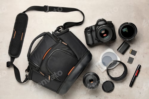 Preview: Professional photographer's equipment and case on light background, flat lay