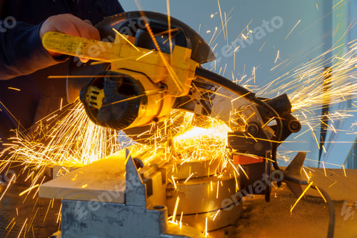 Preview: Metal sawing, worker man. Sparks while grinding iron