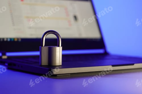 Preview: Locked metal padlock on a laptop keyboard over blue background. Cyber security concept.
