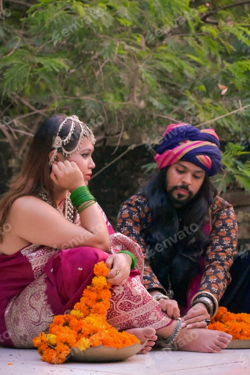 Preview: Indian man with long hair wearing turban sitting beside woman in