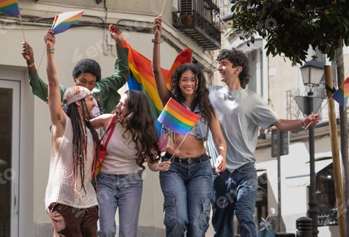 Preview: Excited young activists celebrating with rainbow flags at pride parade