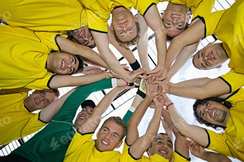 Preview: Football team putting hands together