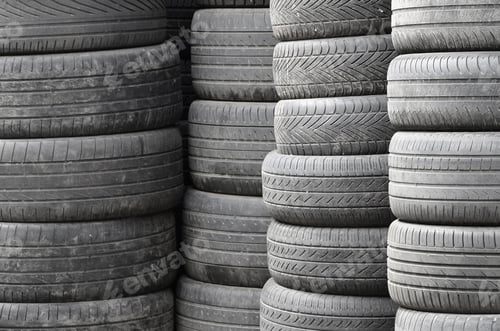 Preview: Old used tires stacked with high piles in secondary car parts shop garage