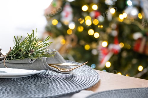 Preview: Serving a festive table with plates, forks, knives, napkins close-up tissue in a cage decorated for
