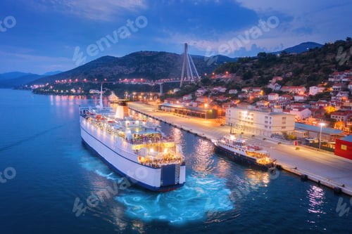 Preview: Aerial view of cruise ship at harbor at night
