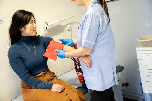 Preview: Healthcare professional examining patient's arm in a medical practice