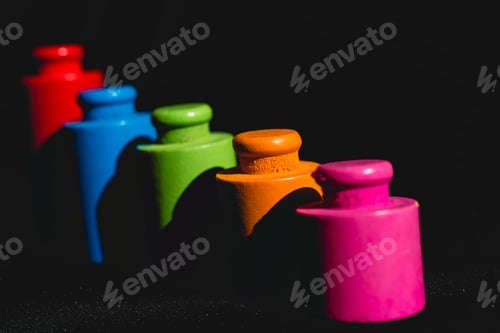 Preview: Round pieces of wood colors on black background.