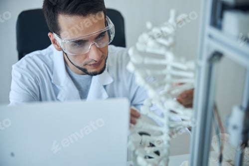 Preview: Medical student sitting at a desk in a laboratory