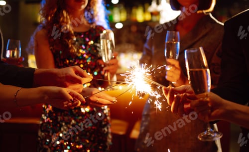 Preview: Glowing sparkles in hands. Group of happy people enjoying party with fireworks. Winter holiday.