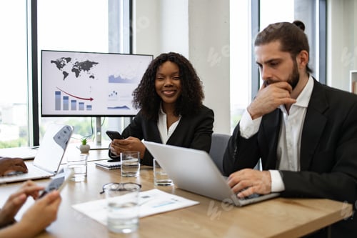 Preview: Business team meeting in a modern office with charts and graphs