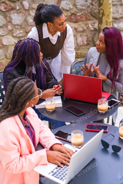 Preview: Young businesswomen of black ethnicity. In a business meeting in a cafeteria