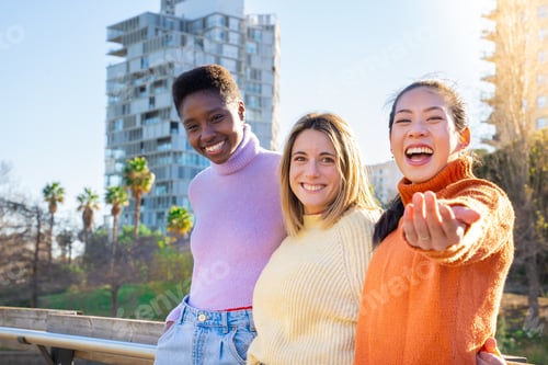 Preview: Friends are sharing a happy moment, smiling for a picture in a park enjoying the fun together.