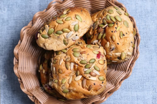 Preview: top view of sunflower seed baked bread in a bowl on table