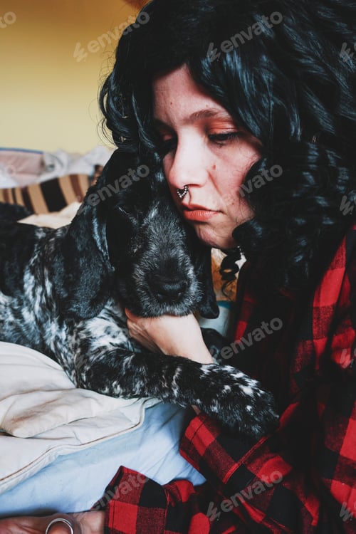 Preview: Cute shot of a young woman spending time with her dog