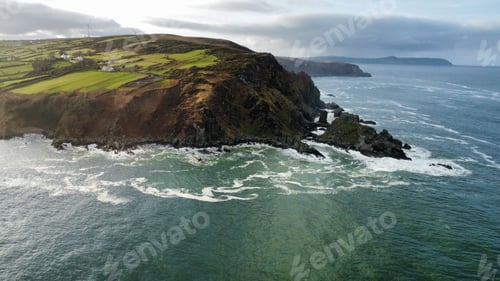 Preview: Majestic scene of towering cliffs and lush green fields near the Inishowen Coast