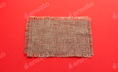 Preview: Burlap napkin on red color background