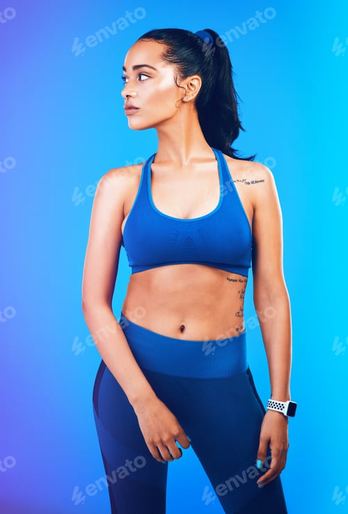 Preview: Studio shot of an attractive young sportswoman posing against a blue background