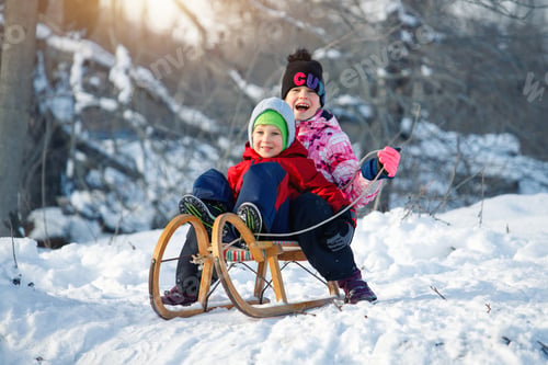 Preview: Two cute adorable funny sibling kid friend wear warm jacket enjoy have fun sledging at city park