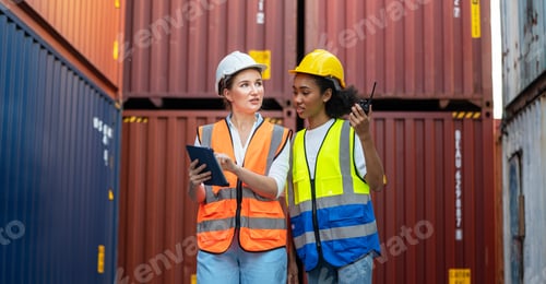 Preview: CEO or Manager in white helmet holding tablet and Woman foreman checking control loading Container