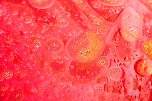 Vista previa: abstract red background formed by oil drops on water