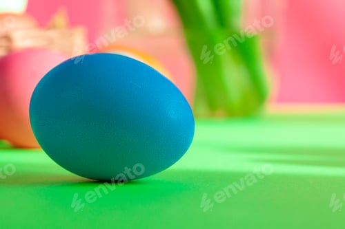 Preview: Blue colored Easter egg close up on paper background