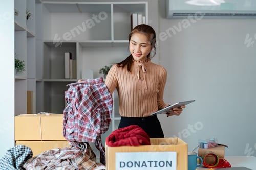 Preview: Diverse young woman organizing clothing donations in a community space, promoting charity and social
