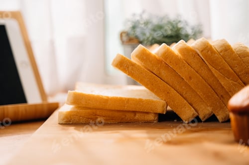Preview: Fresh homemade baked bread and sliced bread on wooden table